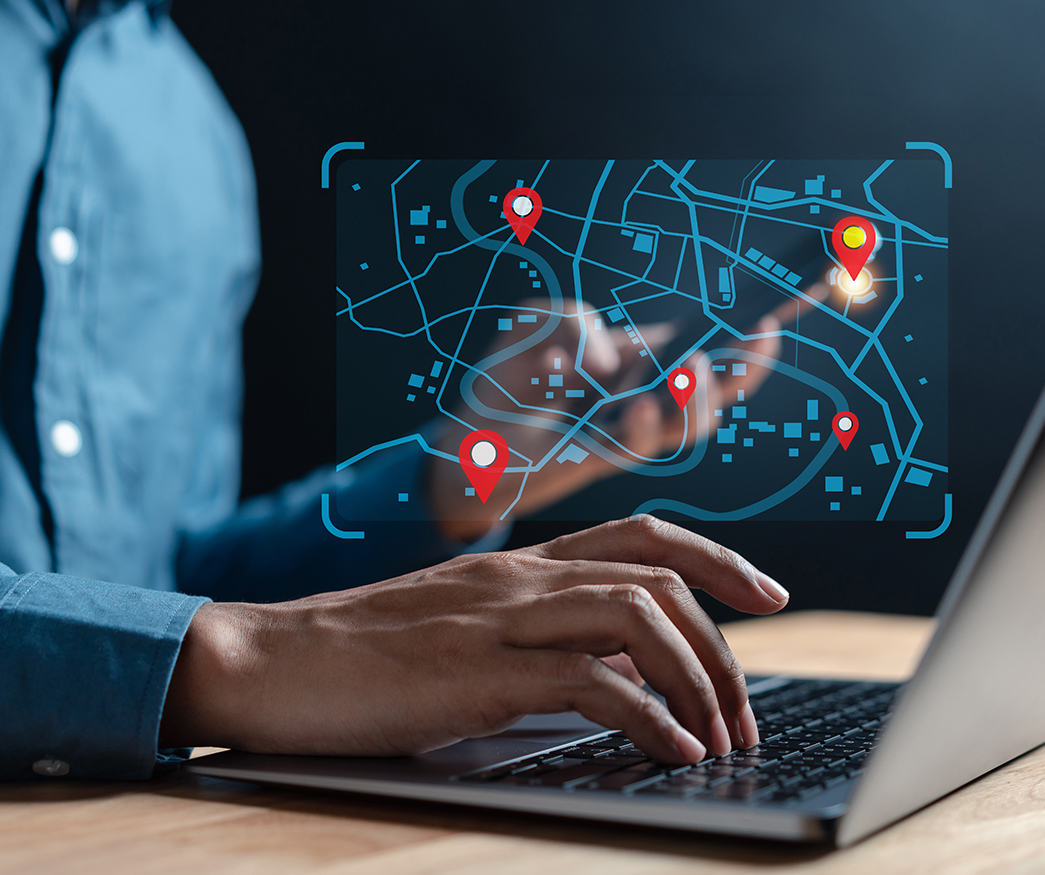 Individual browsing a map on a laptop